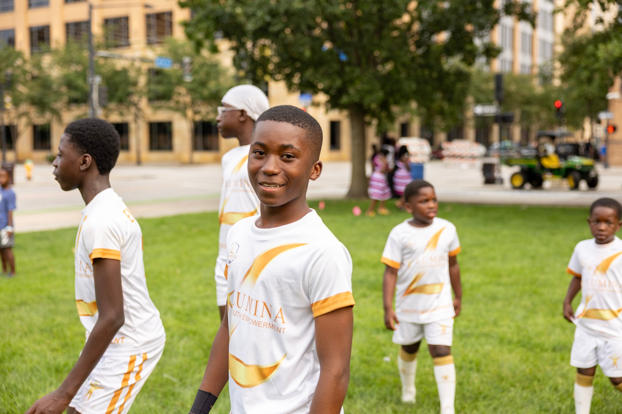 Youth soccer players in Kunina Youth Empowerment uniforms at the festival